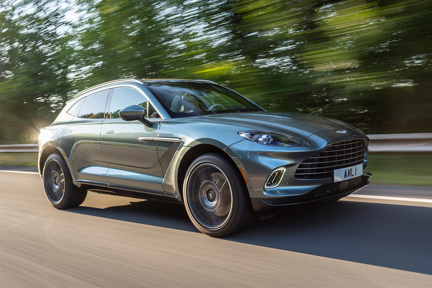 2021 Aston Martin DBX in green driving down the road