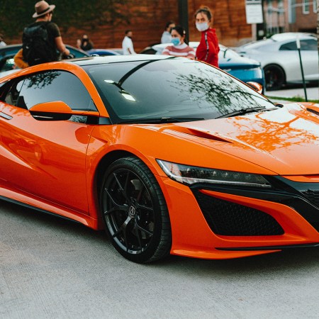 An orange Acura NSX at a car show in Houston, Texas