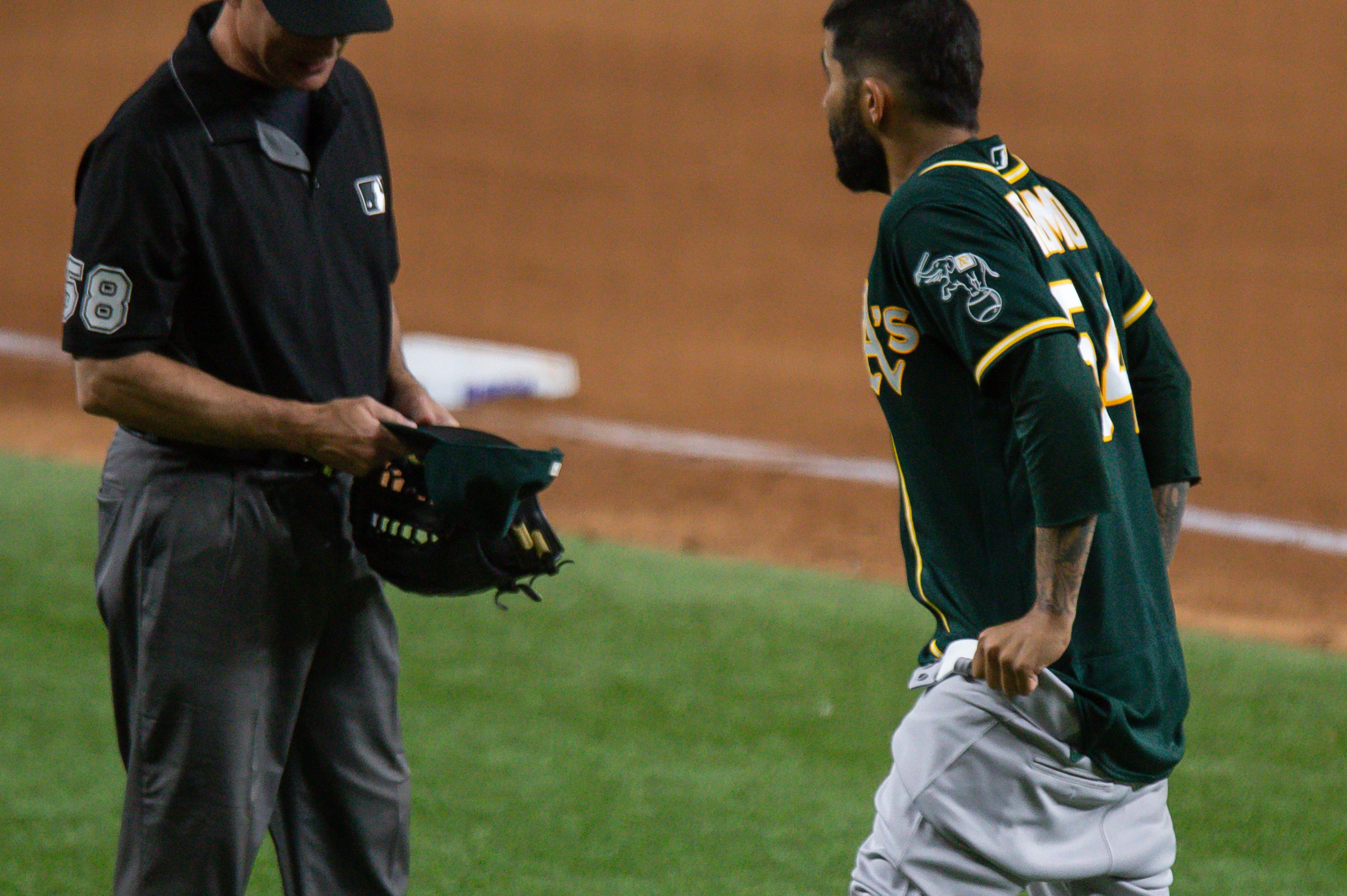 Oakland Athletics Pitcher Sergio Romo pulls down his pants.