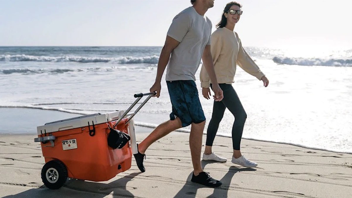 two models dragging a ROVR camping cooler behind them