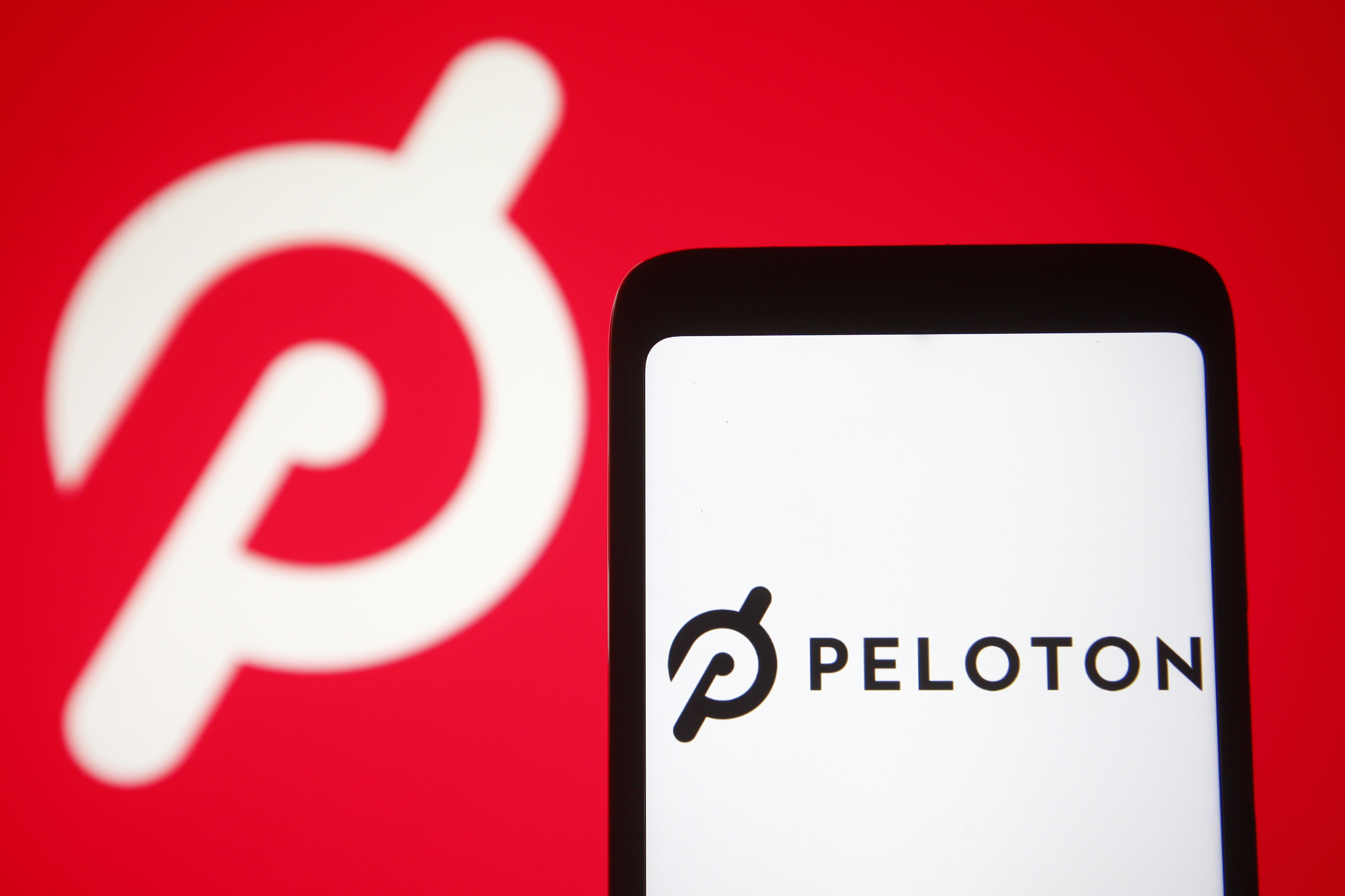 The Peleton logo and a screenshot. It turns out Peloton pays artists significantly more than Spotify or Apple Music.