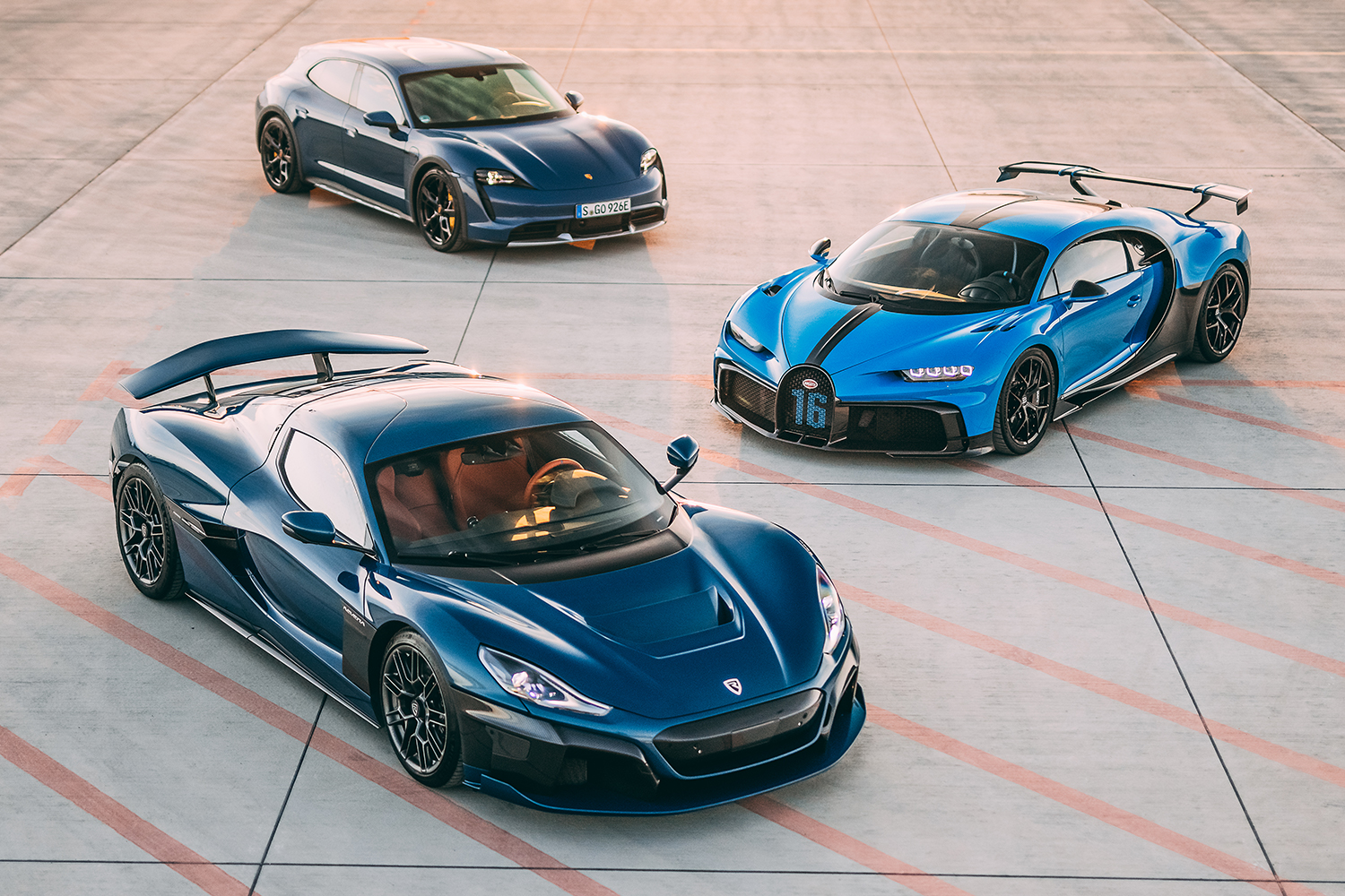 Three cars, one from Porsche, Bugatti and Rimac, all parked next to each other. The three automakers formed a new joint venture, Bugatti Rimac.