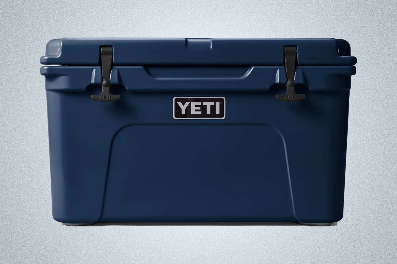 a navy blue YETI Tundra cooler  on a grey background 