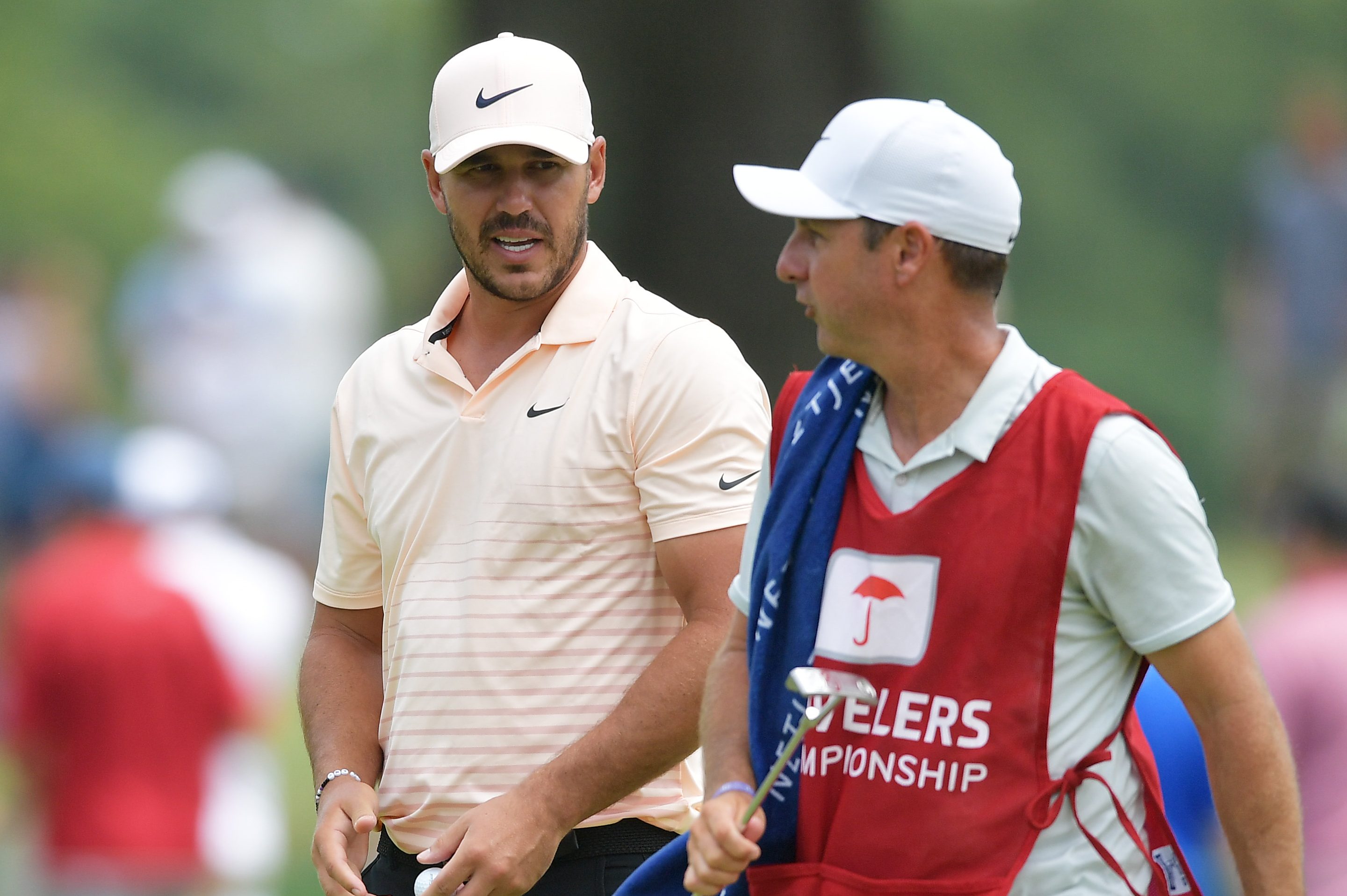 Brooks Koepka talks with his caddie Ricky Elliott. Koepka trolled Bryson DeChambeau over his caddie.