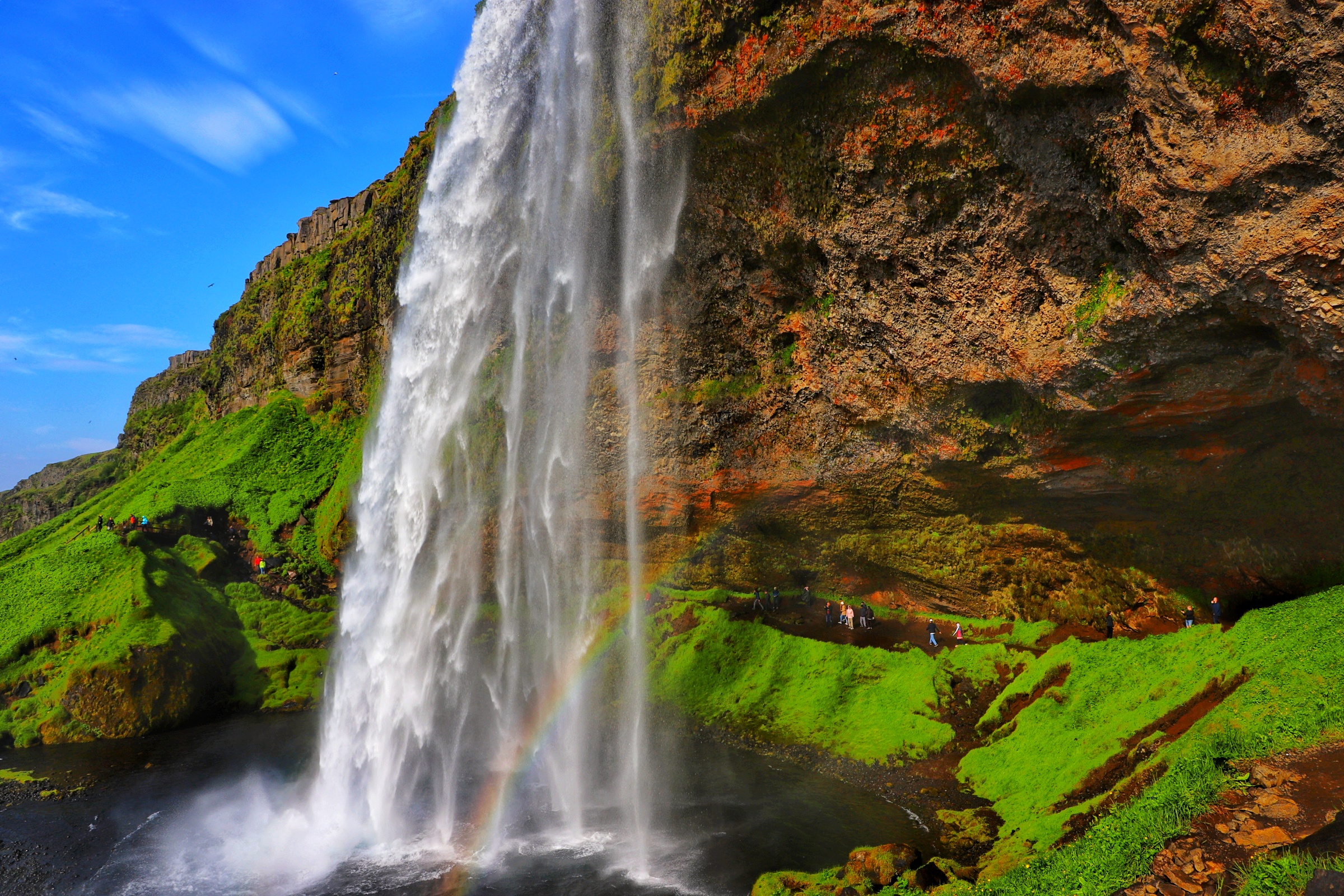 Visitors to Iceland's Seljalandsfoss waterfall are able to enjoy a view looking out from beyond the falls