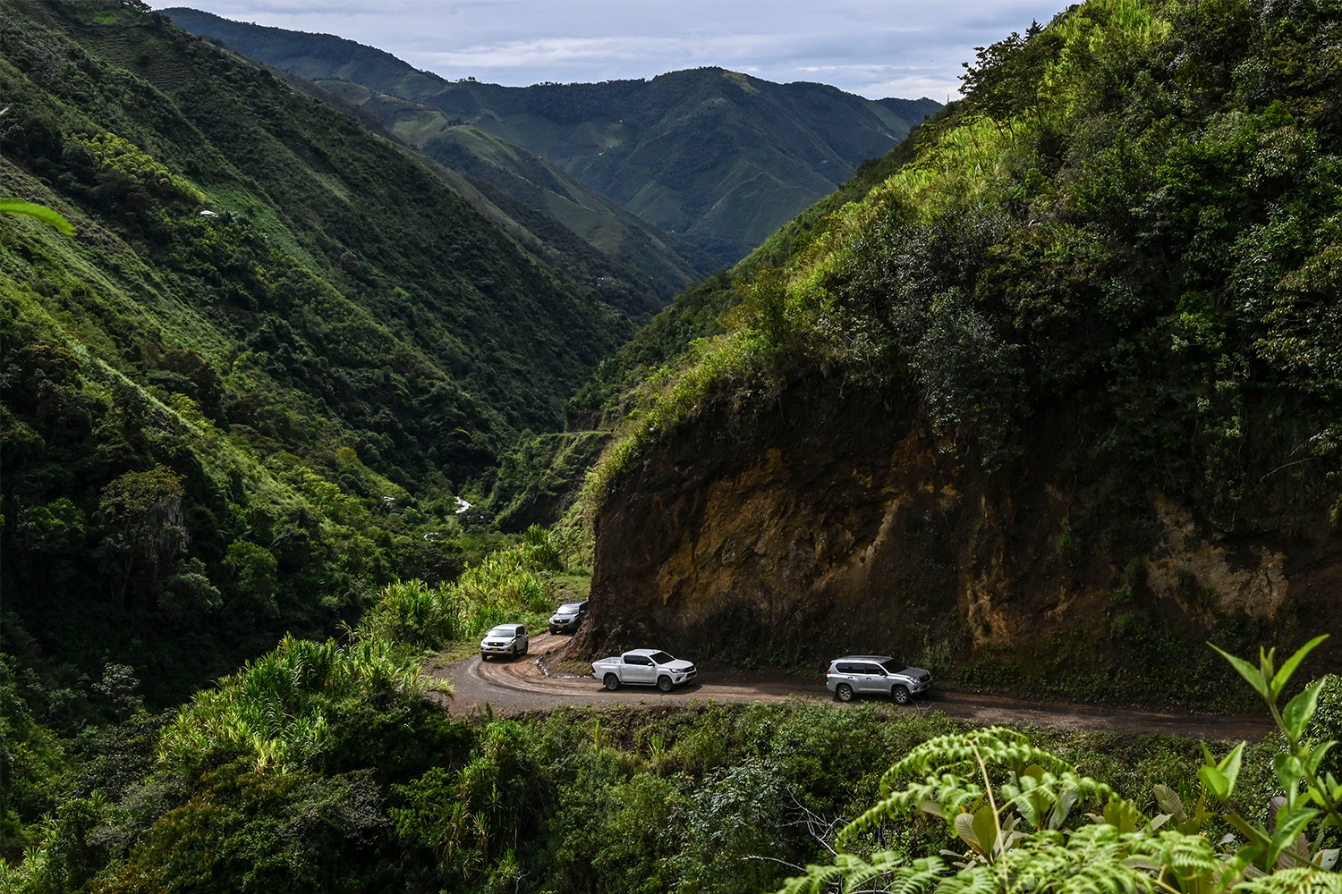 A security caravan transporting a former FARC guerrilla commander drives through the jungle near Ituango in Colombia