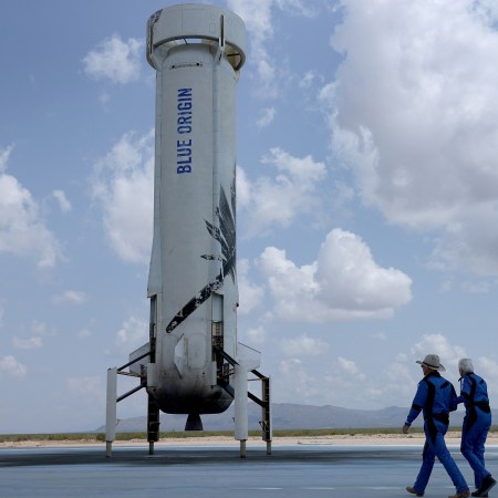 Blue Origin’s New Shepard crew (L-R) Jeff Bezos, Wally Funk, Oliver Daemen, and Mark Bezos walk near the booster to pose for a picture after flying into space in the Blue Origin New Shepard rocket on July 20, 2021 in Van Horn, Texas. Mr. Bezos and the crew were the first human spaceflight for the company. And now you can buy a replica of the rocket for $69.