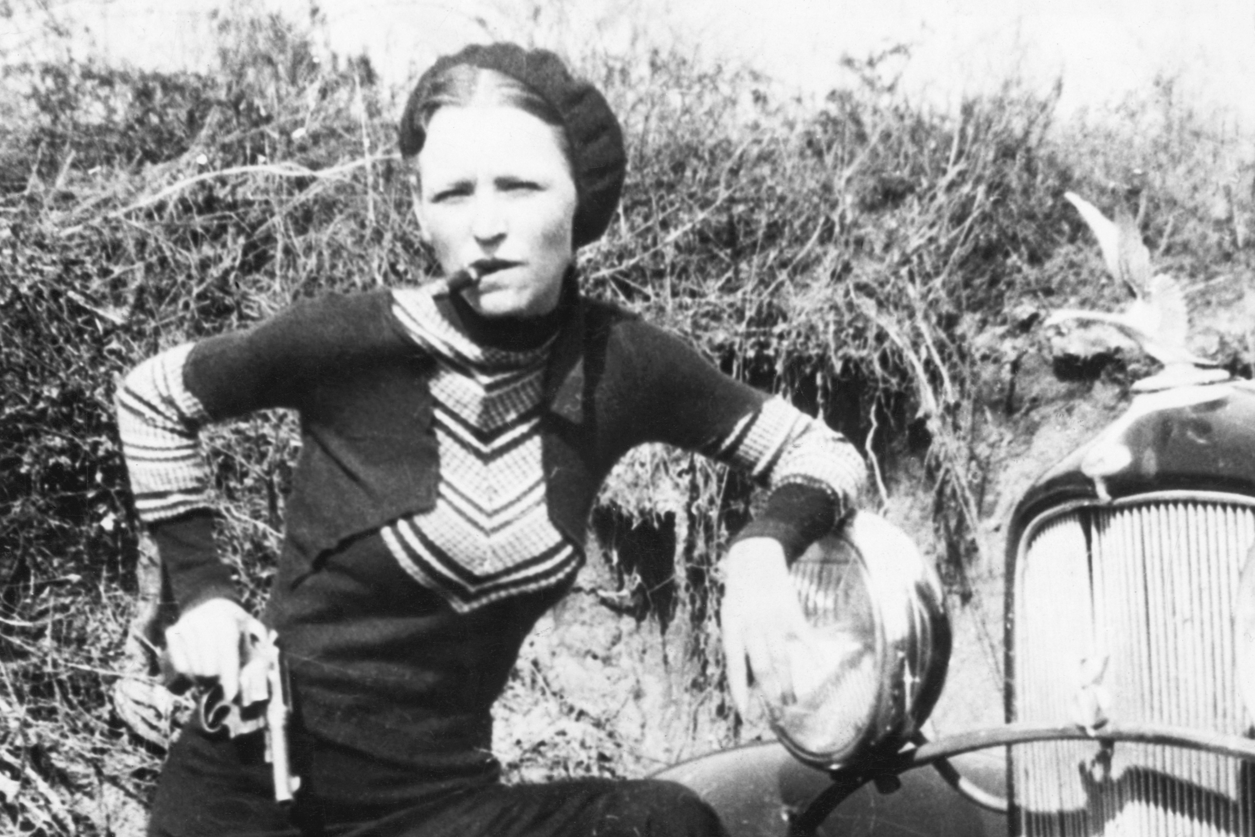 Bonnie Parker, partner of Clyde Barrow, smoking a cigar