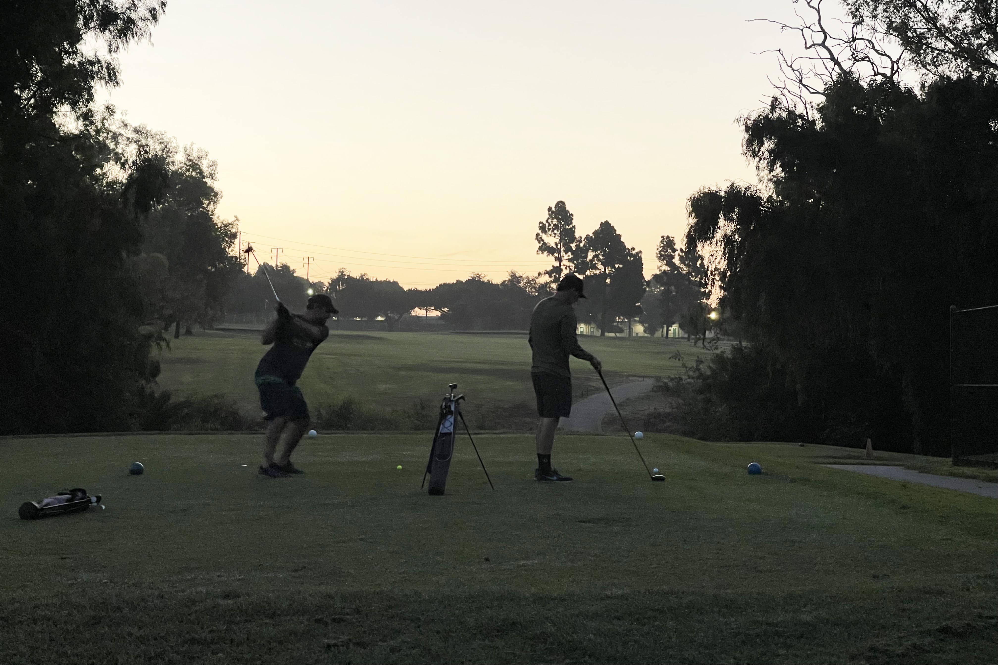 speedgolfers teeing off in the dark