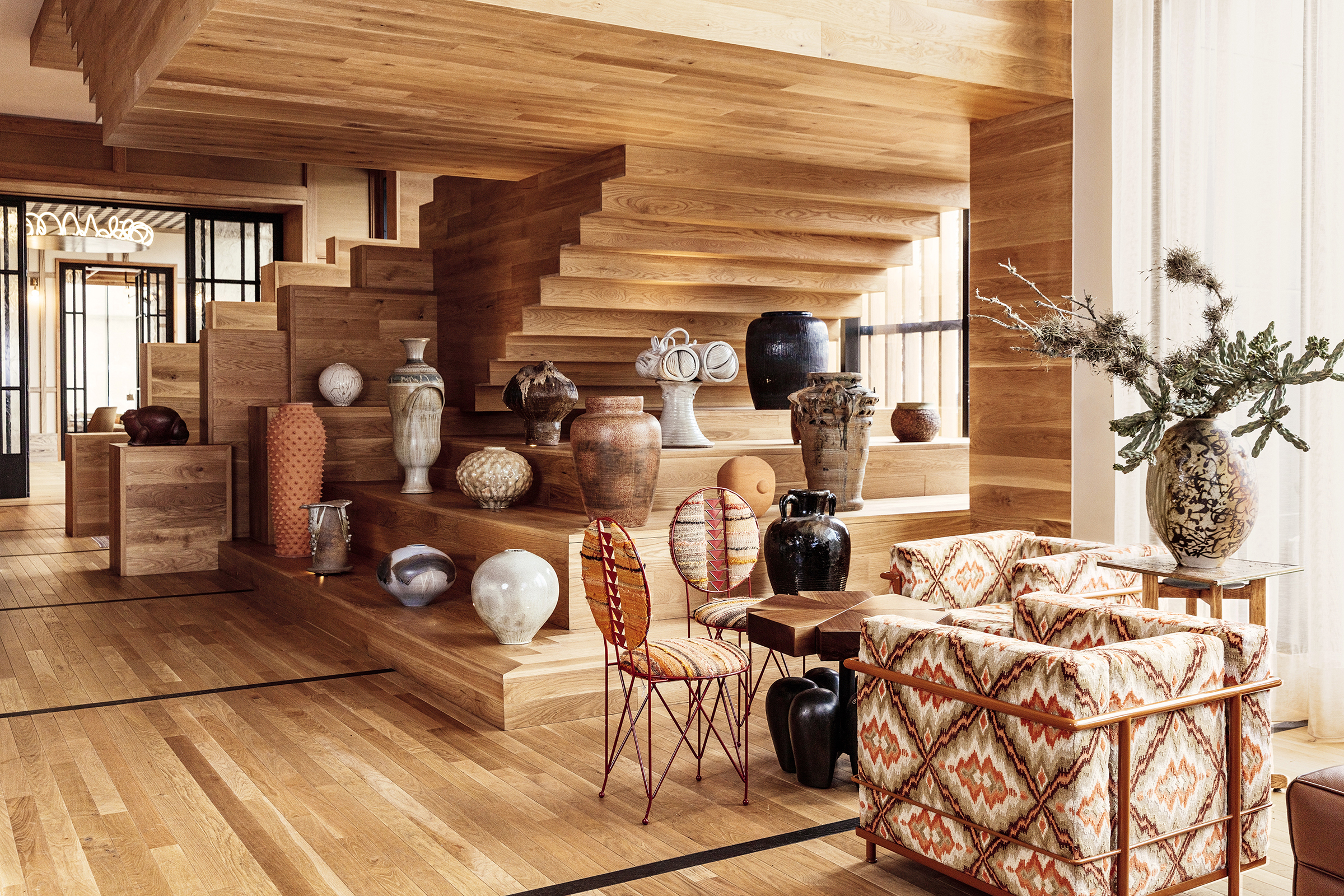 an installation of ceramics and vases in the lobby of the proper hotel in austin