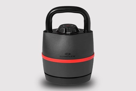 An adjustable kettlebell from Bowflex in red and black on a grey background. The workout equipment is on sale on Amazon.