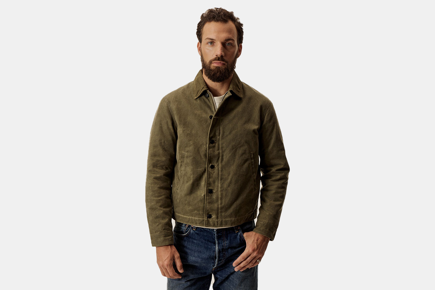 a green waxed jacket on a bearded model.