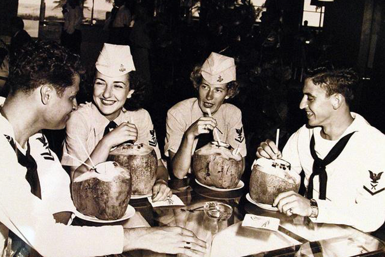 US Navy servicemen and women drinking piña coladas at the Caribe Hilton, c. 1953