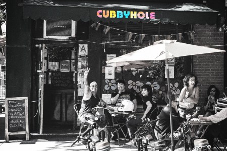 Customers pose and make hand gestures outside Cubbyhole, a well known lesbian & gay bar, in the West Village on June 17, 2021 in New York City.