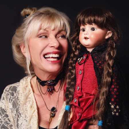 hollywood with patti negri holds a porcelain doll with braided hair