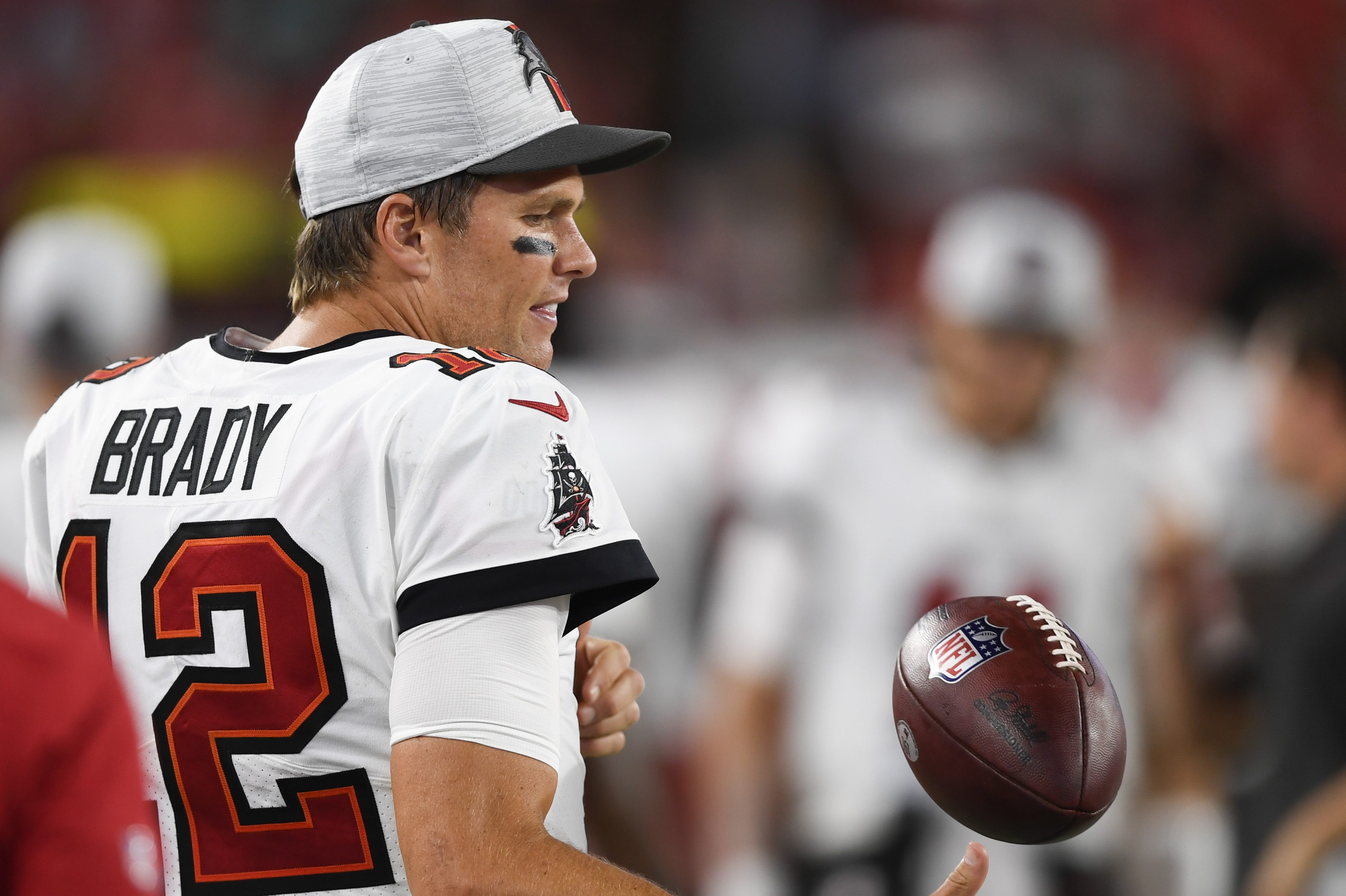 Tom Brady of the Tampa Bay Buccaneers warms up on the sideline of an NFL game