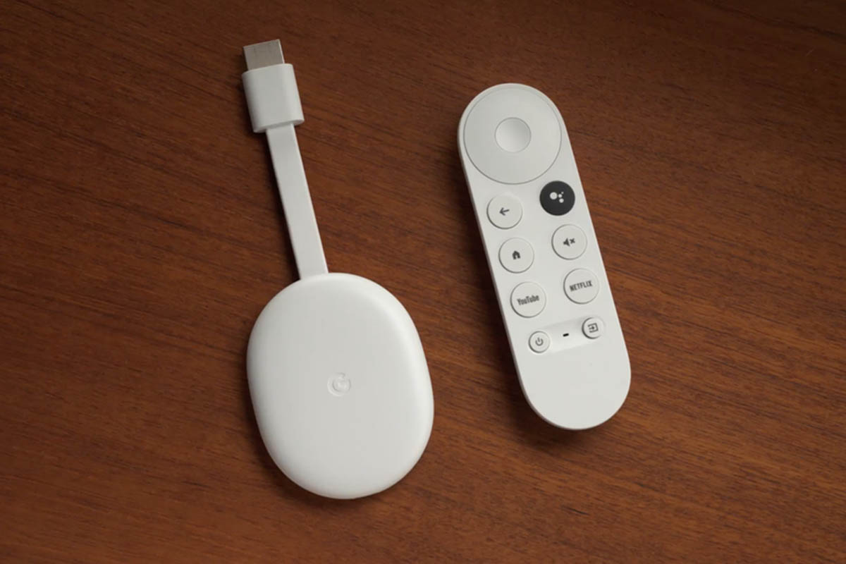 Chromecast with Google TV device and remote, sitting on a table. Our review praises the organization the service brings to streaming