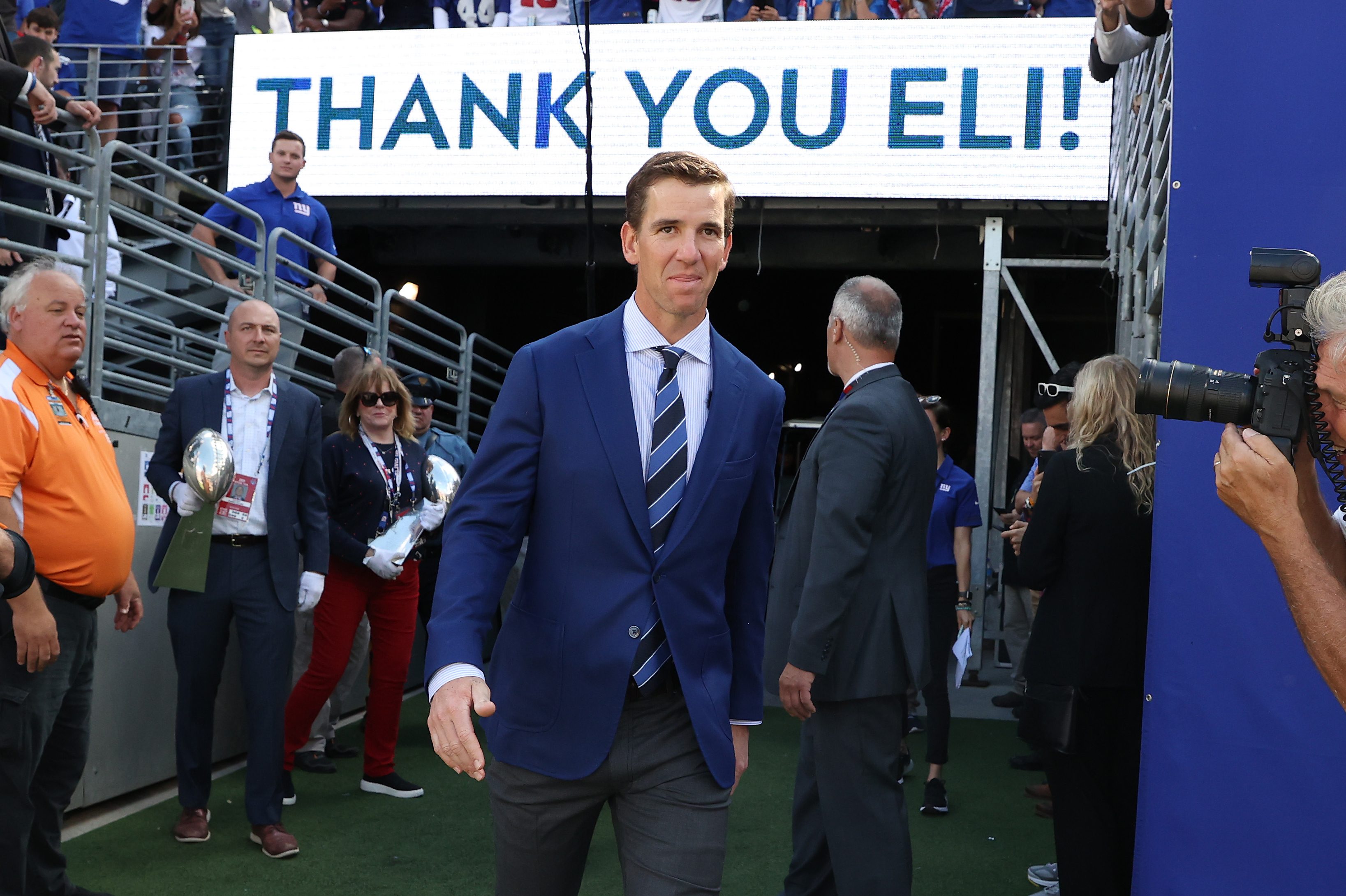 Eli Manning walks onto the field during his ring of honor induction ceremony