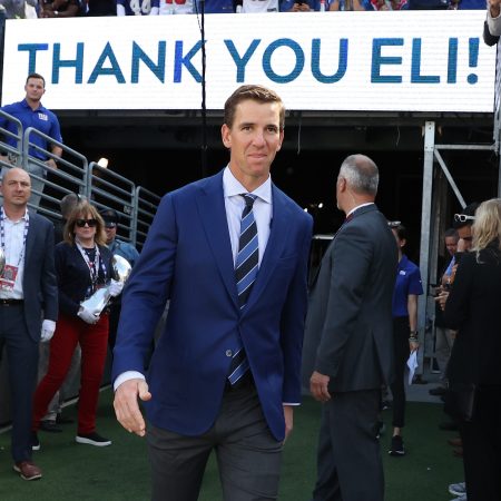 Eli Manning walks onto the field during his ring of honor induction ceremony