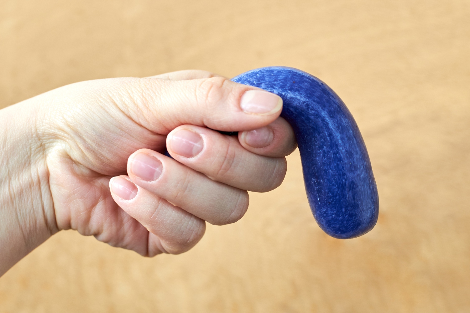 A toy made of plasticine in the hand of a woman, the theme of sexual dysfunctions, the toy symbolizes the penis. Covid-19 may be causing impotence.