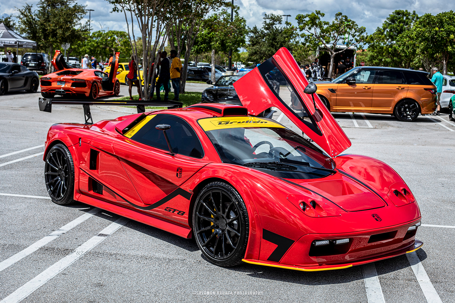 The 2020 Grullón GT8, a supercar made from a Corvette, from DDR Motorsport sitting in a parking lot with other expensive caras