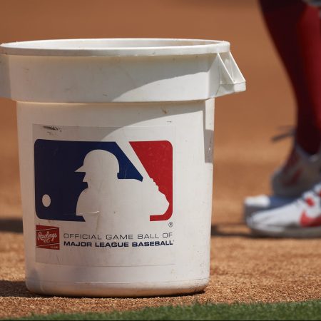 A bucket with the MLB logo on it on the field before a game