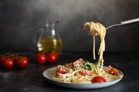 spaghetti with amatriciana sauce in the dish on the wooden table