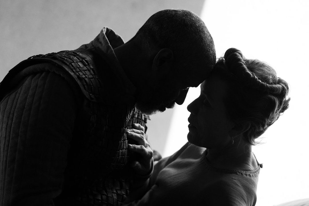 Denzel Washington and Frances McDormand touching heads in a scene from "The Tragedy of Macbeth," a black-and-white take on the Shakespearean tale from Joel Coen