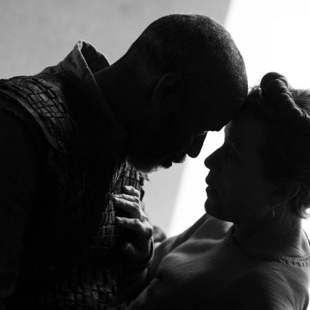 Denzel Washington and Frances McDormand touching heads in a scene from "The Tragedy of Macbeth," a black-and-white take on the Shakespearean tale from Joel Coen