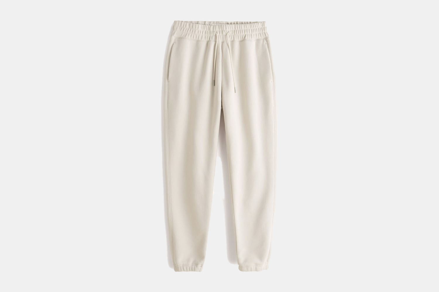 a pair of cream sweatpants 