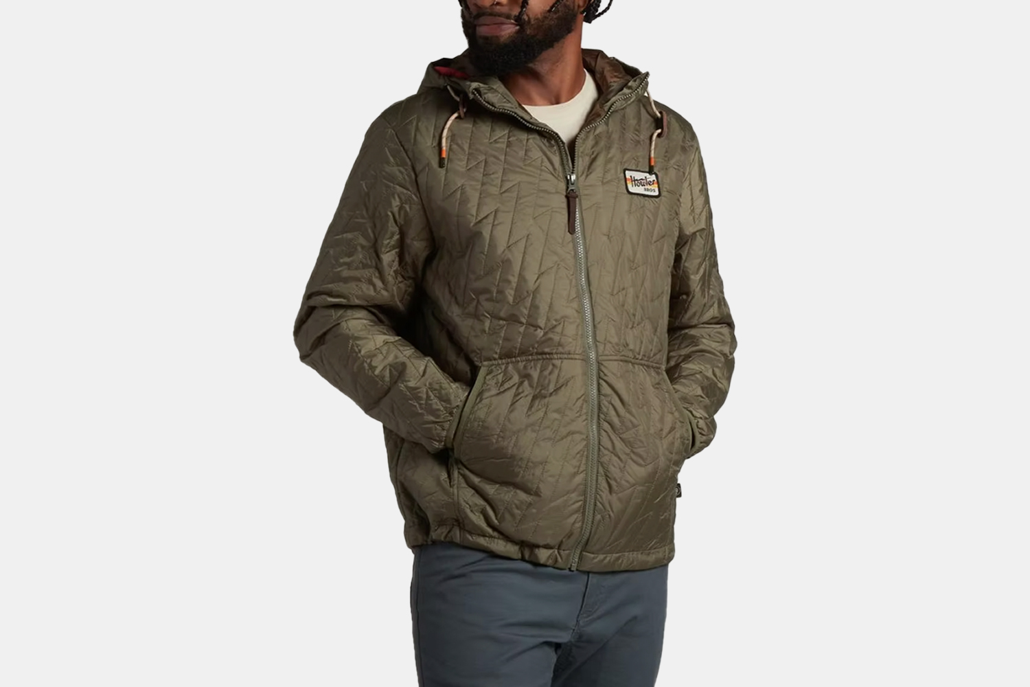 a green zip up puffer jacket