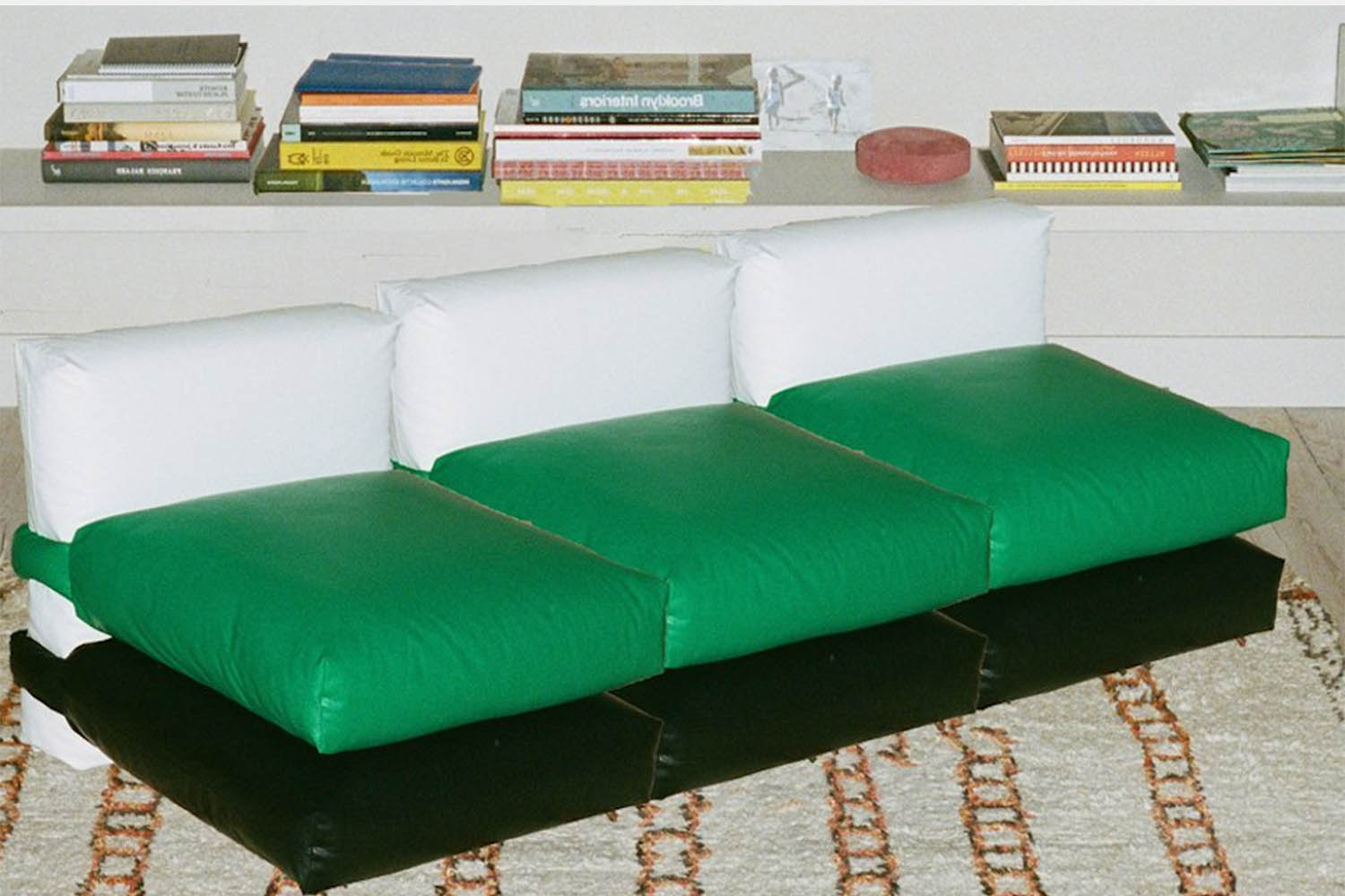 a green sofa made out of pillows.