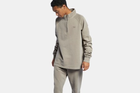 A man wearing the Reebok Classics Natural Dye Sweatshirt and matching sweatpants