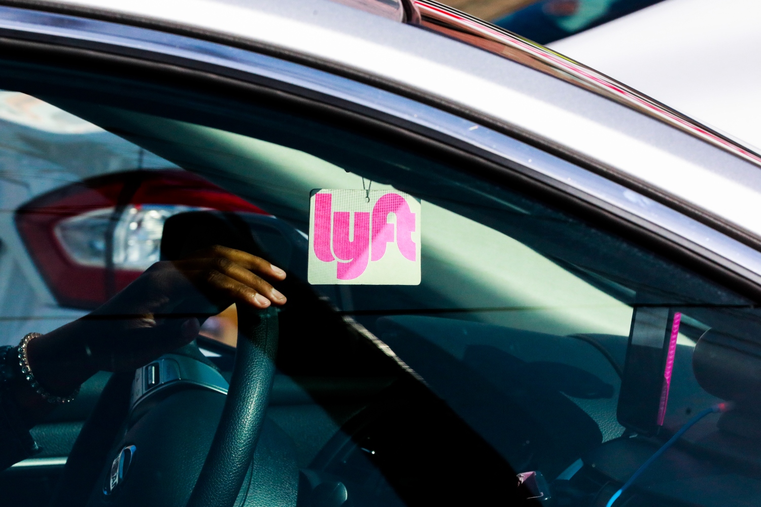 A Lyft decal is seen through the window of a car outside the Cal Train station on Townsend Street in San Francisco, California, on Monday, May 20, 2019.