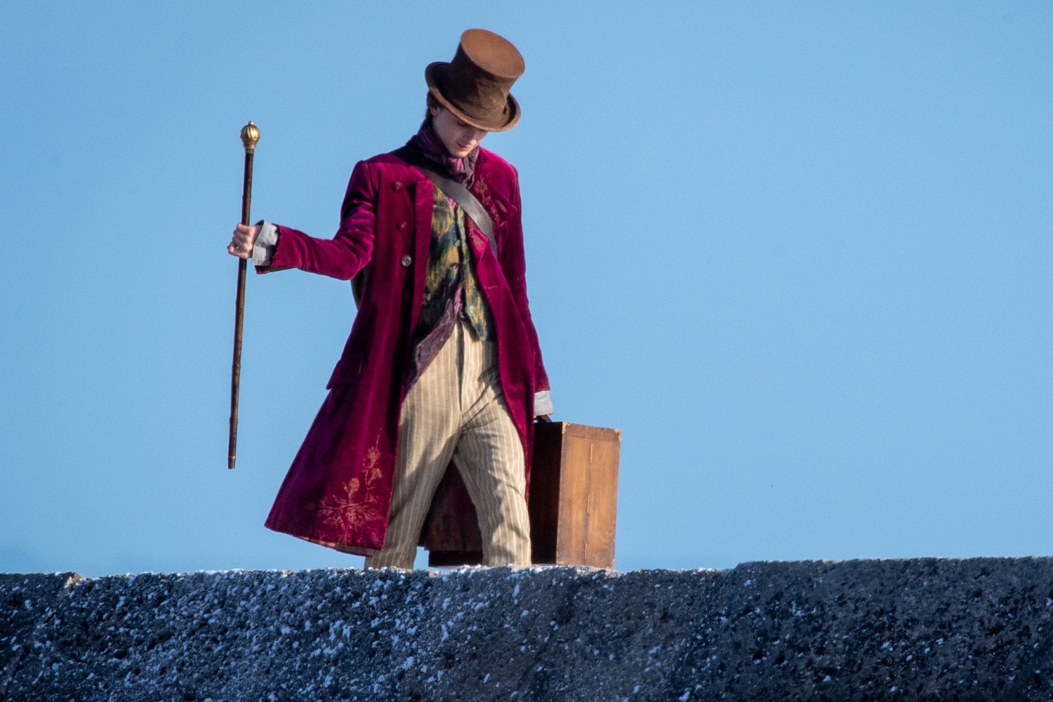 Timothée Chalamet is seen as Willy Wonka during filming for the Warner Bros and the Roald Dahl Story Company's upcoming movie 'Wonka' on October 11, 2021, in Lyme Regis, England. This film will focus on the young Willy Wonka on his earliest adventure and how he met the Oompa-Loompas. Some critics contend Chalamet is too "hot" to play Wonka