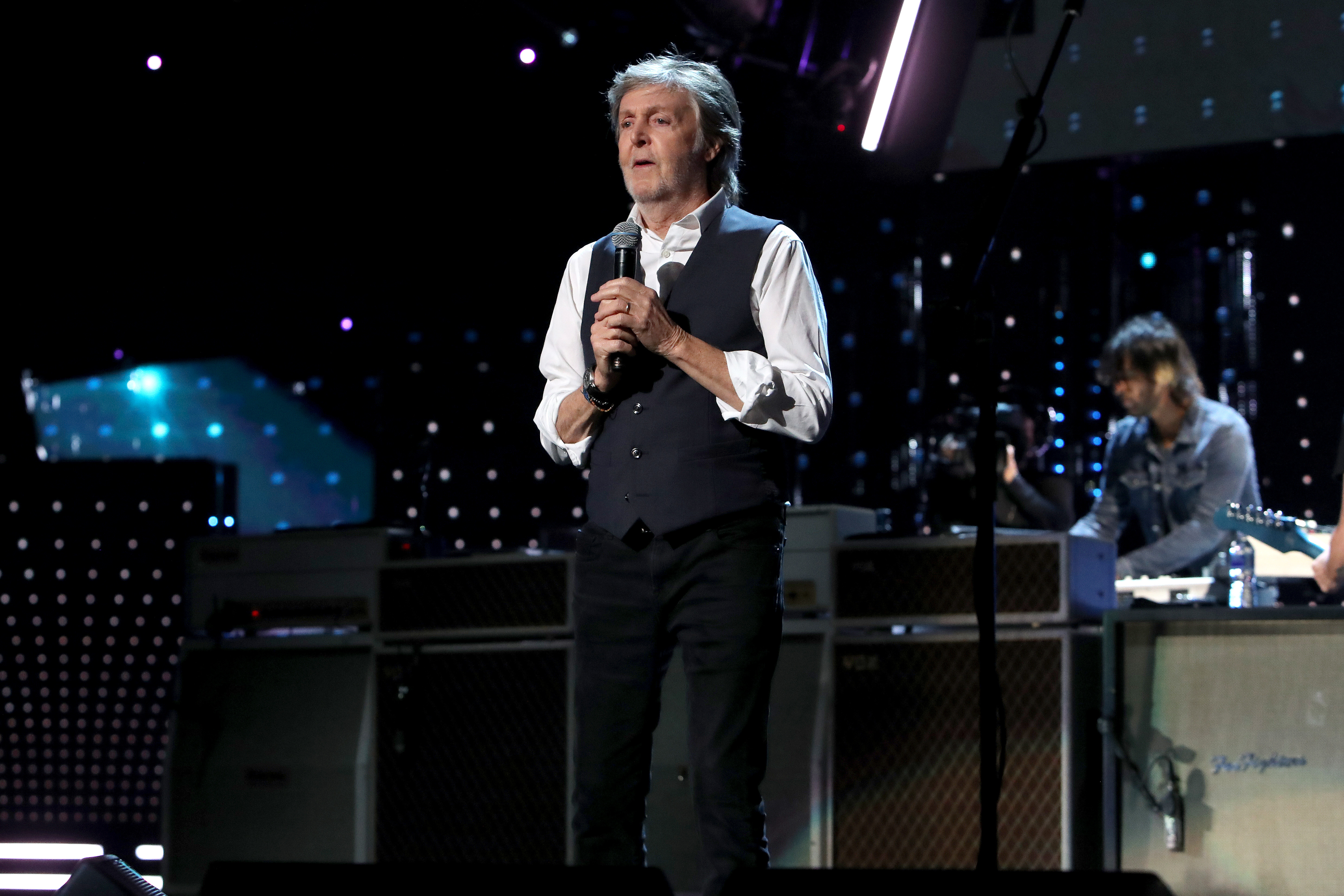 Paul McCartney speaks onstage during the 36th Annual Rock & Roll Hall Of Fame Induction Ceremony at Rocket Mortgage Fieldhouse on October 30, 2021 in Cleveland, Ohio. The former Beatle says a new documentary has made him change his perception on his old band's breakup.