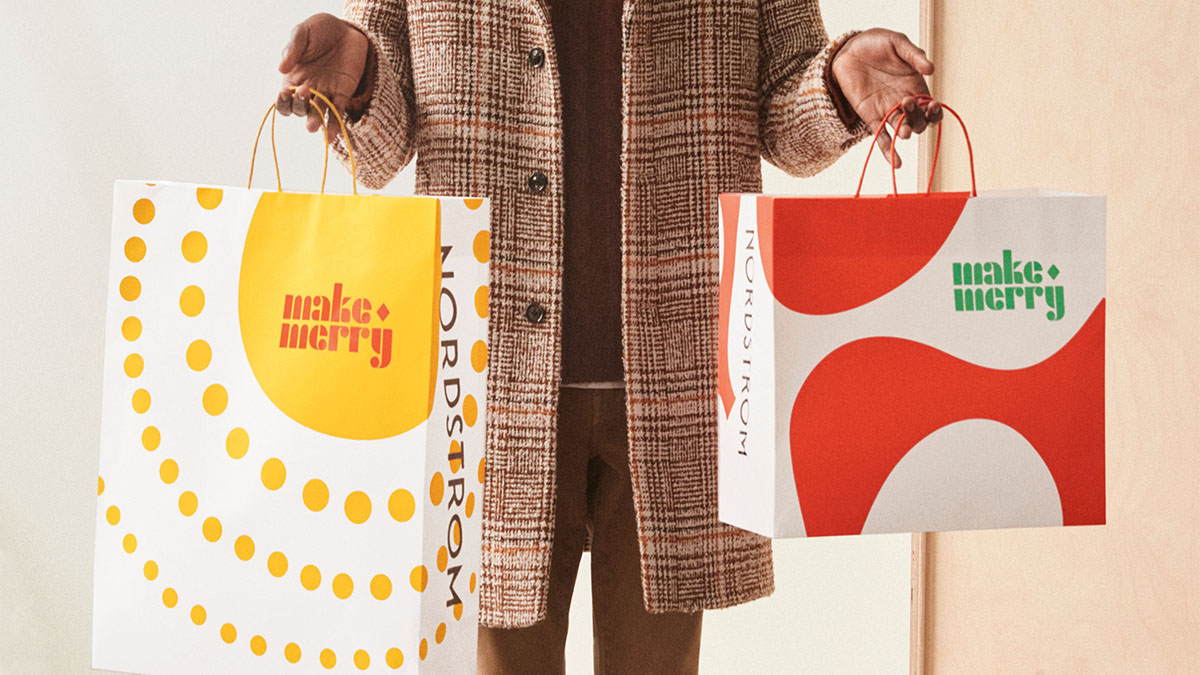 a man holding two shopping bags