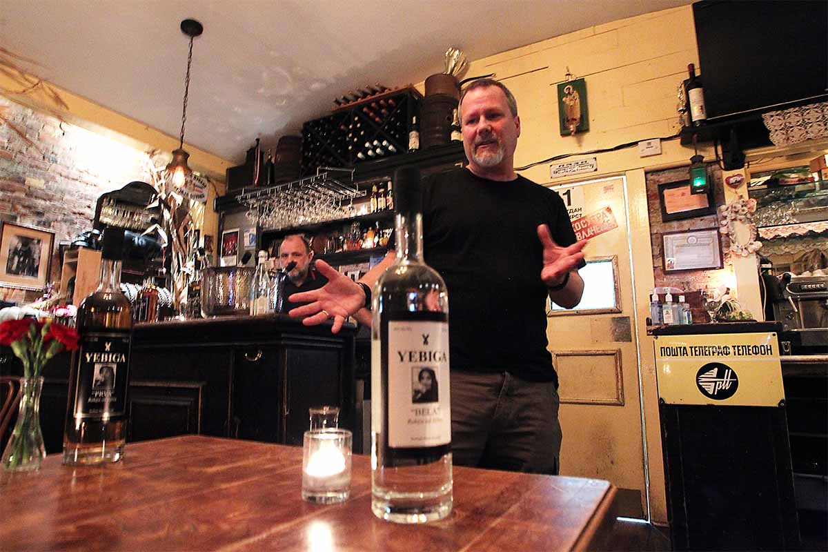 Bill Gould with a bottle of Yebiga Bela, an unaged rakija