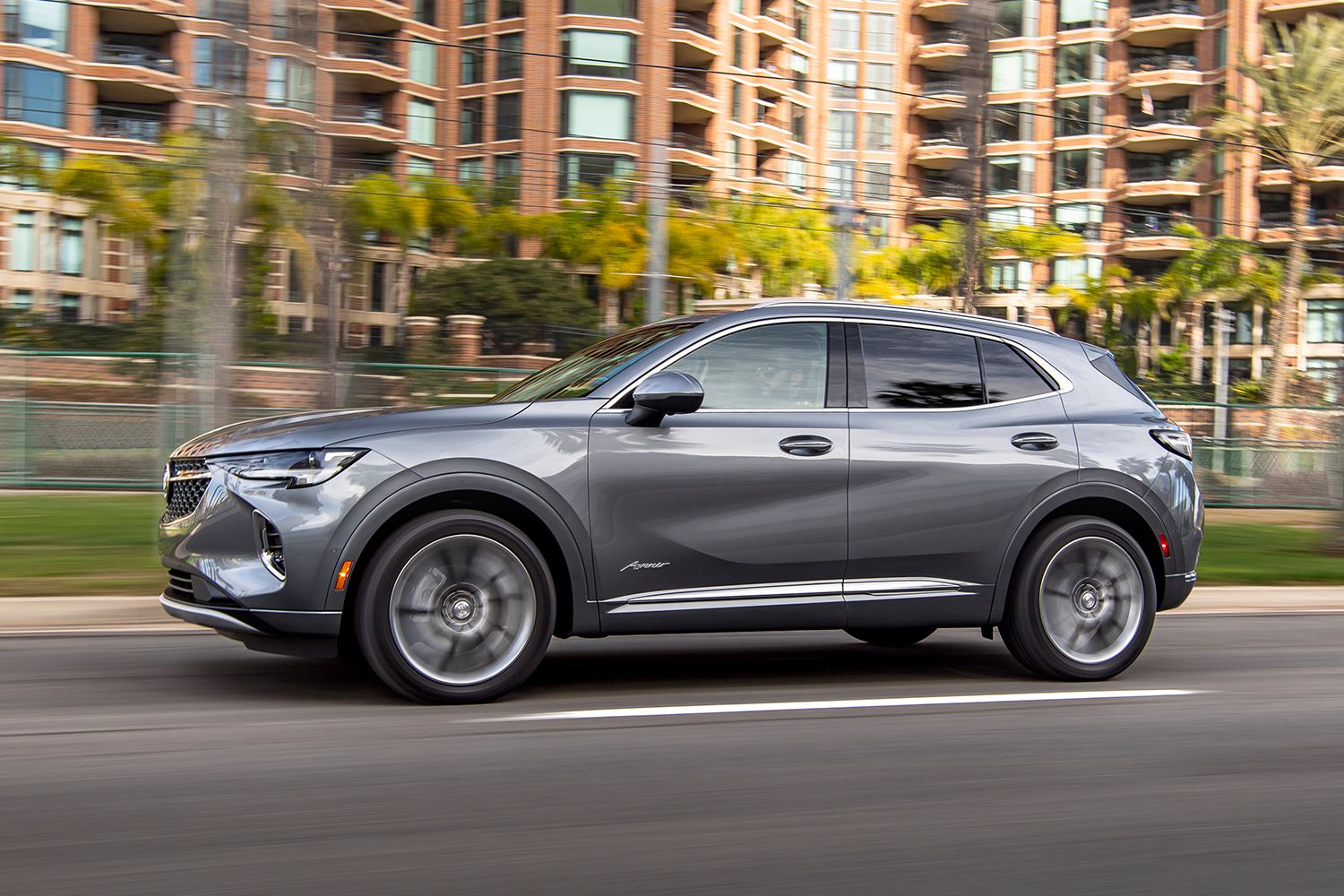 The Buick Envision SUV driving down the road. The compact SUV leads its class in reliability according to Consumer Reports.