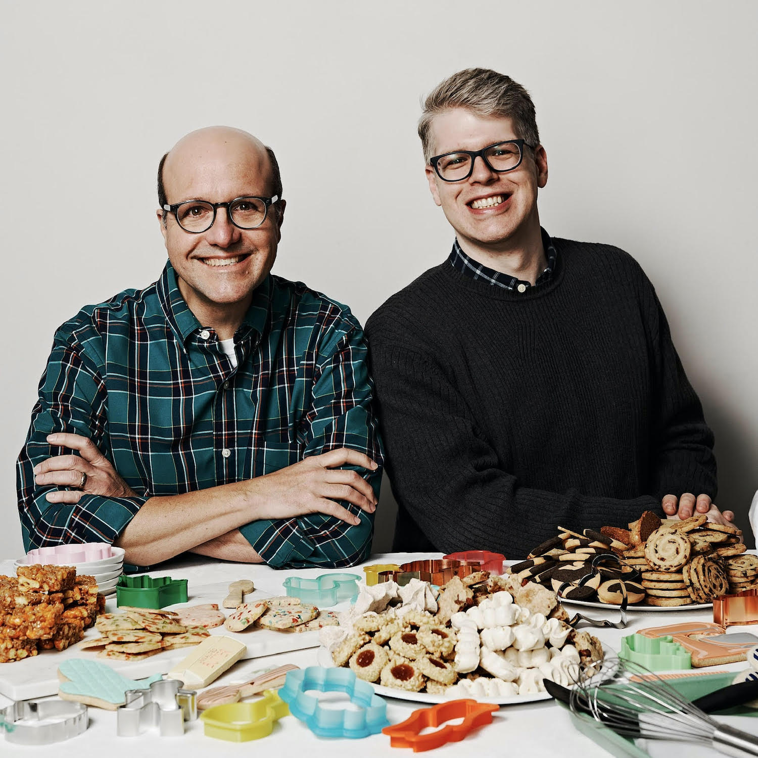 Pie experts and bakers Paul Arguin (left) and Chris Taylor, sitting behind a table full of artfully decorated cookies