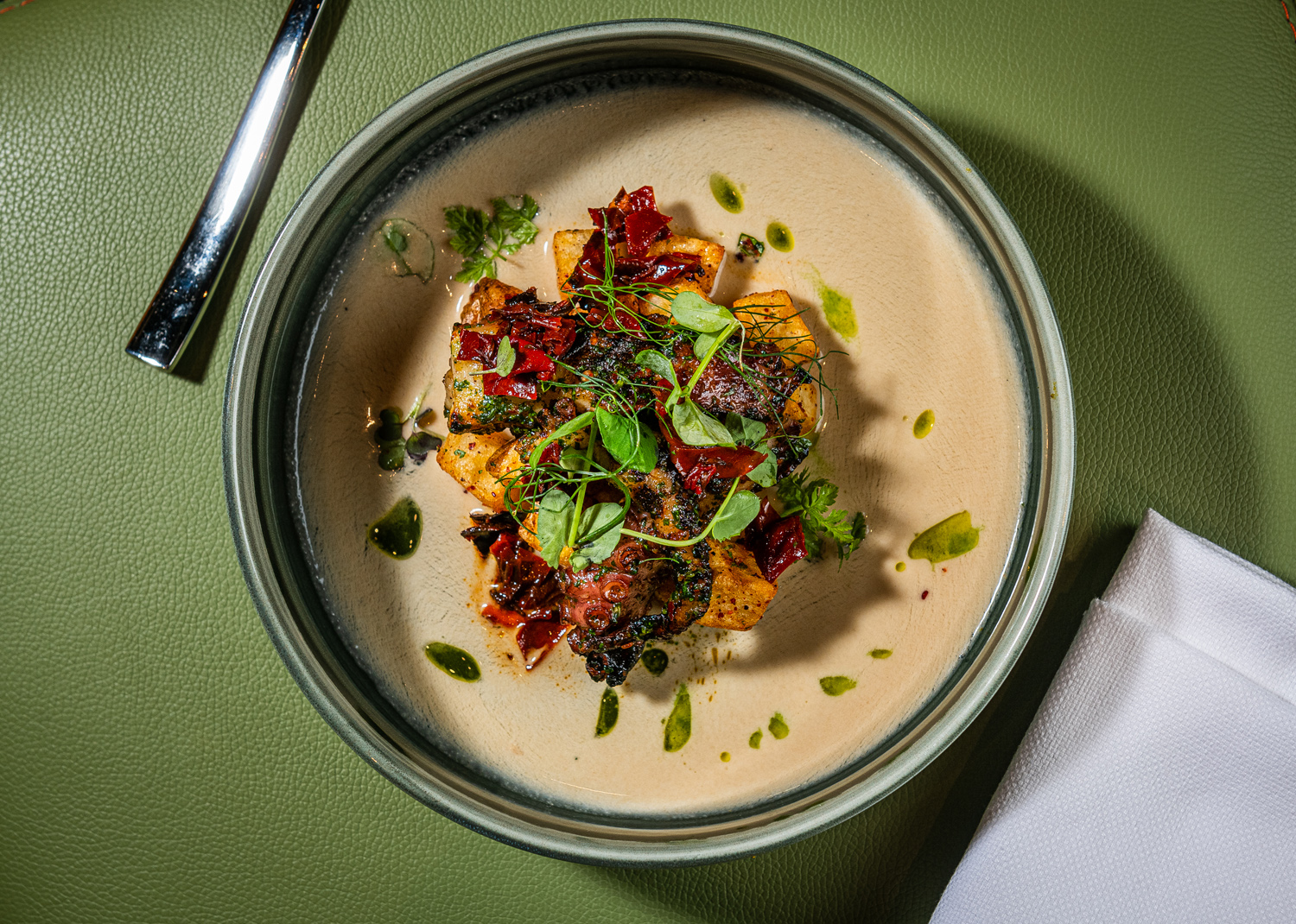 Charred octopus with ajo blanco, batata harra, roasted red pepper from Ilili restaurant in Washington, DC