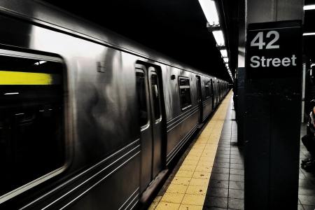 The Times Square Subway Station showing a train in the station and a sign reading "42 Street"