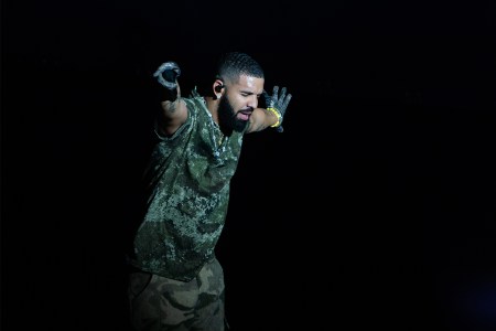 Drake performing against a black background. An anecdotal study revealed that listening to Drake makes runners run slower.