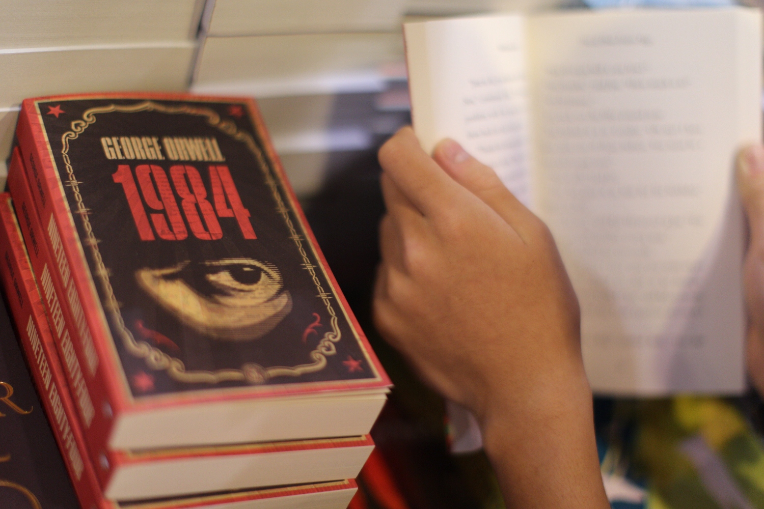 A boy reads a book next to copies of British writer George Orwell's 1984 at Hong Kong's annual book fair on July 15, 2015.