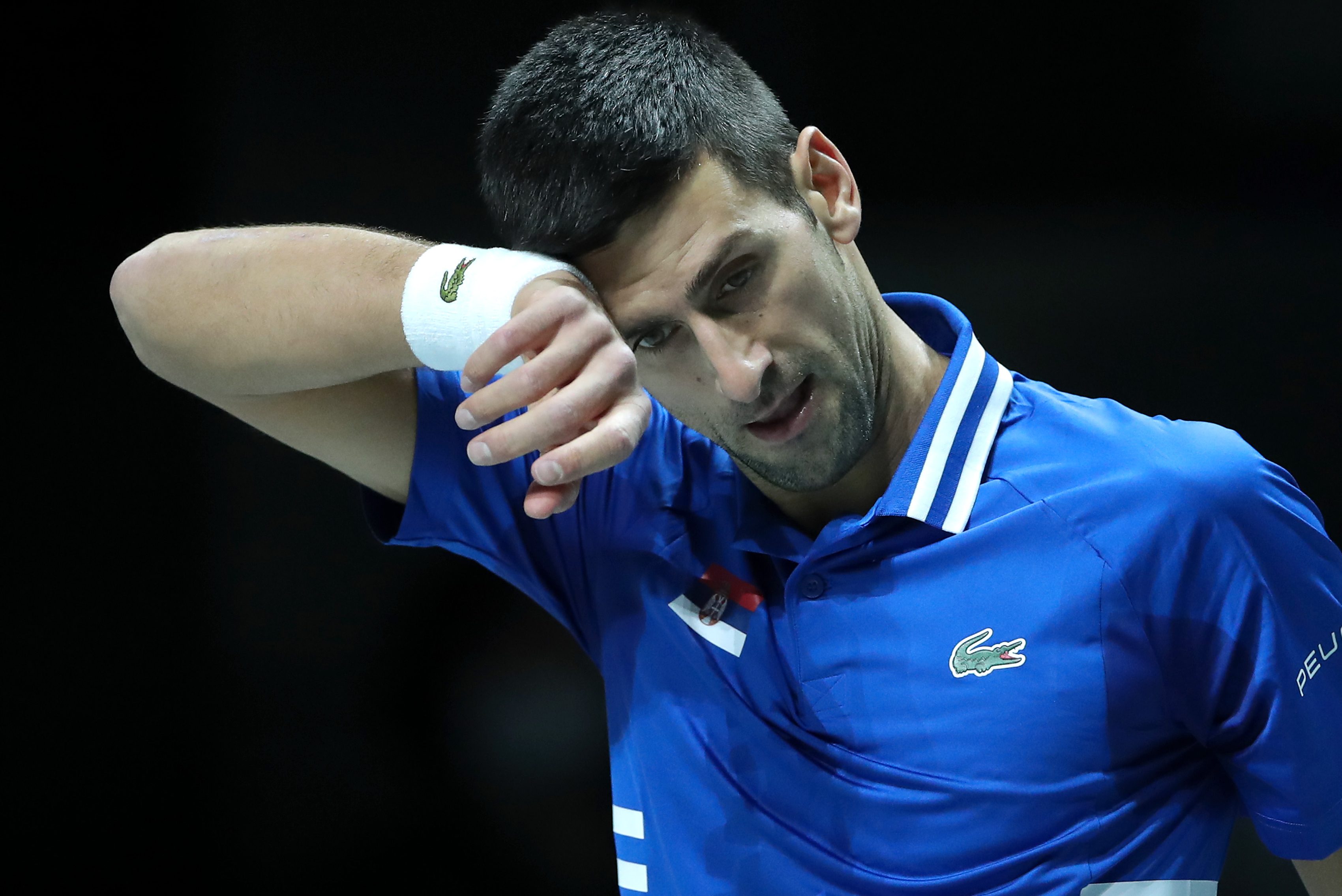 Novak Djokovic of Serbia wipes away sweat during a Davis Cup semifinal match