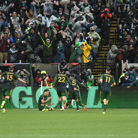 The Portland Timbers react to a game equalizing goal by Portland Timbers forward Felipe Mora, sitting, in stoppage time during the MLS Cup Final between the Portland Timbers and New York City FC.