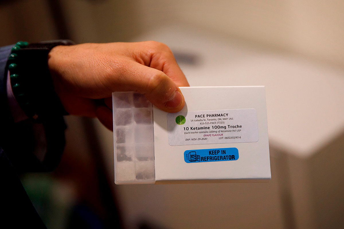 A man holding a small dosage of ketamine.