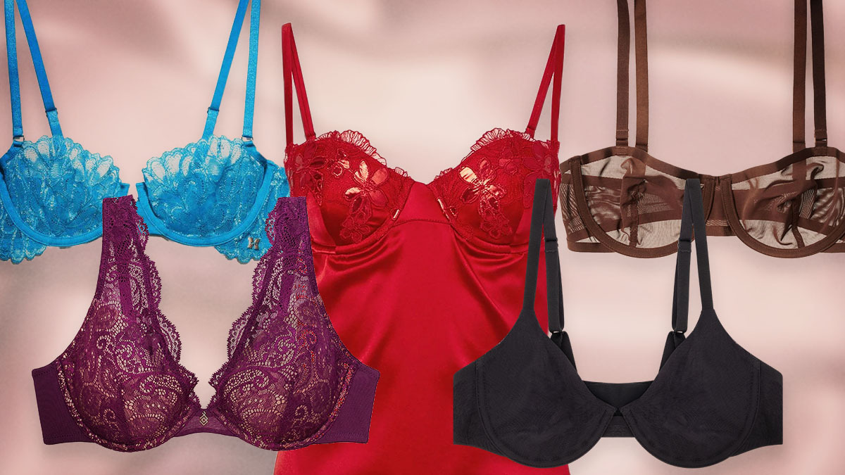 A blue bra, purple bra, brown bra and black bra surrounding a red silk slip dress, perfect Valentine's Day gifts, on a pink background.