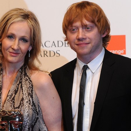 British author JK Rowling (2nd R) and producer David Hayman (L) pose for photographers with British actress Emma Watson (2nd L) and British actor Rupert Grint (R) after receiving their British Academy of Film Award (BAFTA) for 'Outstanding British Contribution to Cinema: Harry Potter' at the Royal Opera House in central London, on February 13, 2011. Grint says the author, who has been accused of being transphobic, is like a troubling "auntie."