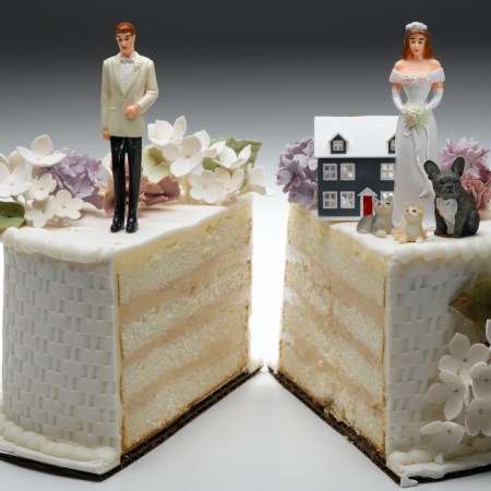 Bride and groom figurines standing on two separated slices of wedding cake